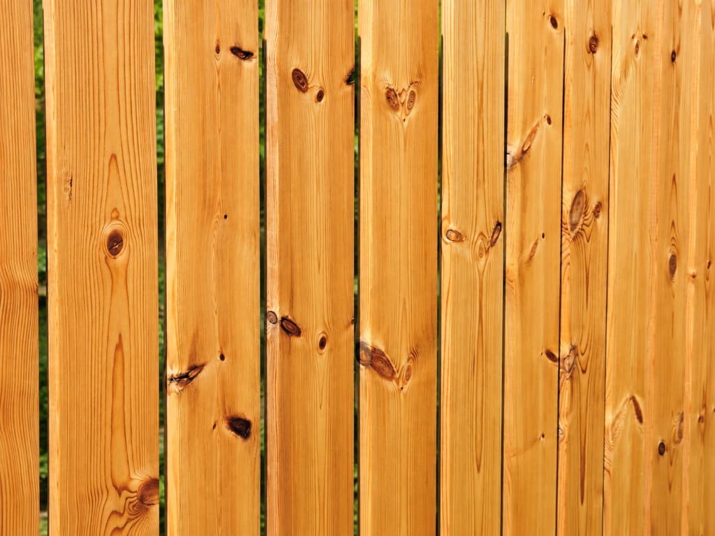 Natural wood fence protected with Nanoclad