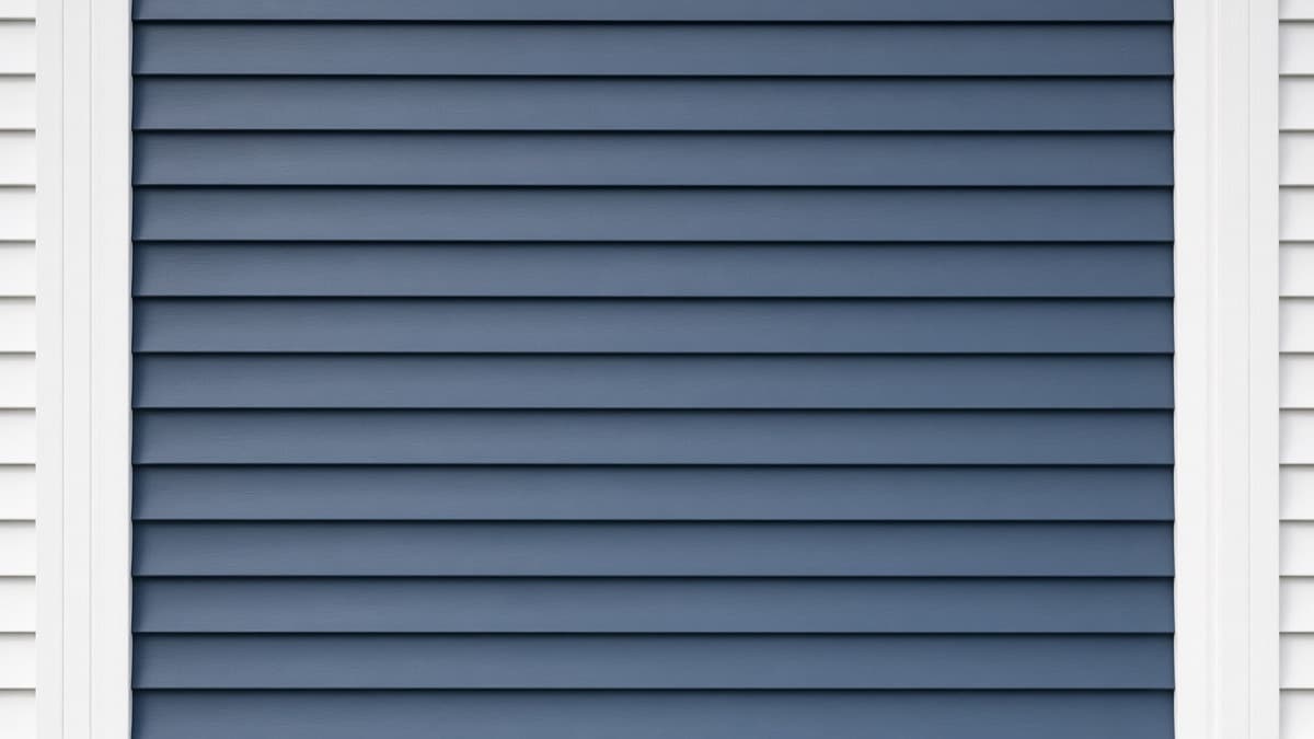 Slate-blue painted lap siding with white corner trim