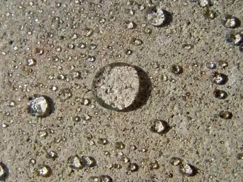 Oil-resistant exposed aggregate driveway treated with Nanoclad Concrete Shield