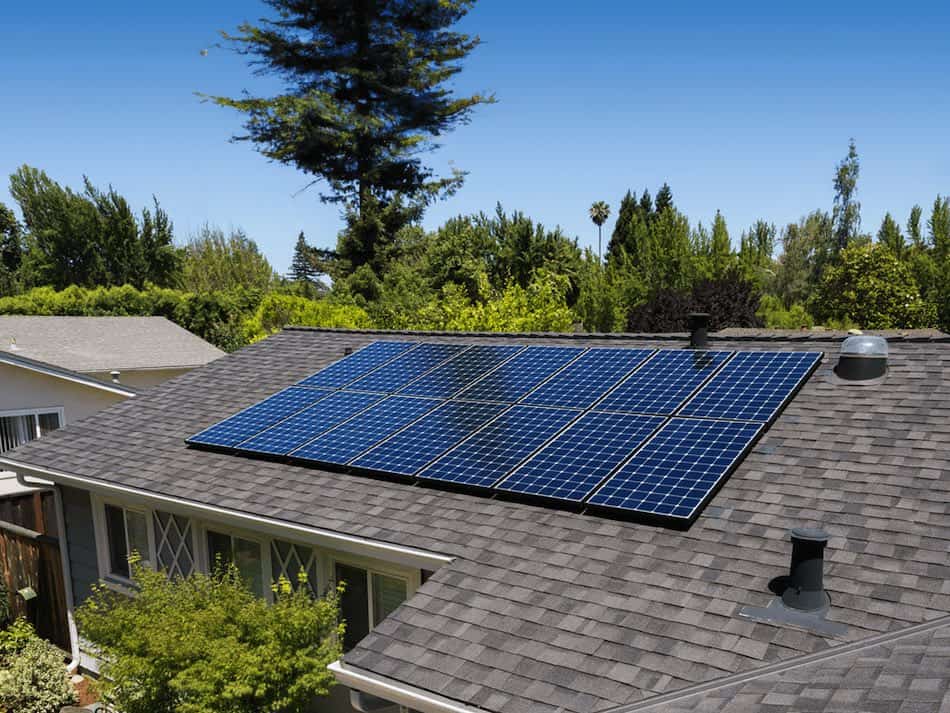 Solar panels installed on an asphalt shingle roof protected with Nanoclad roof preservation treatment