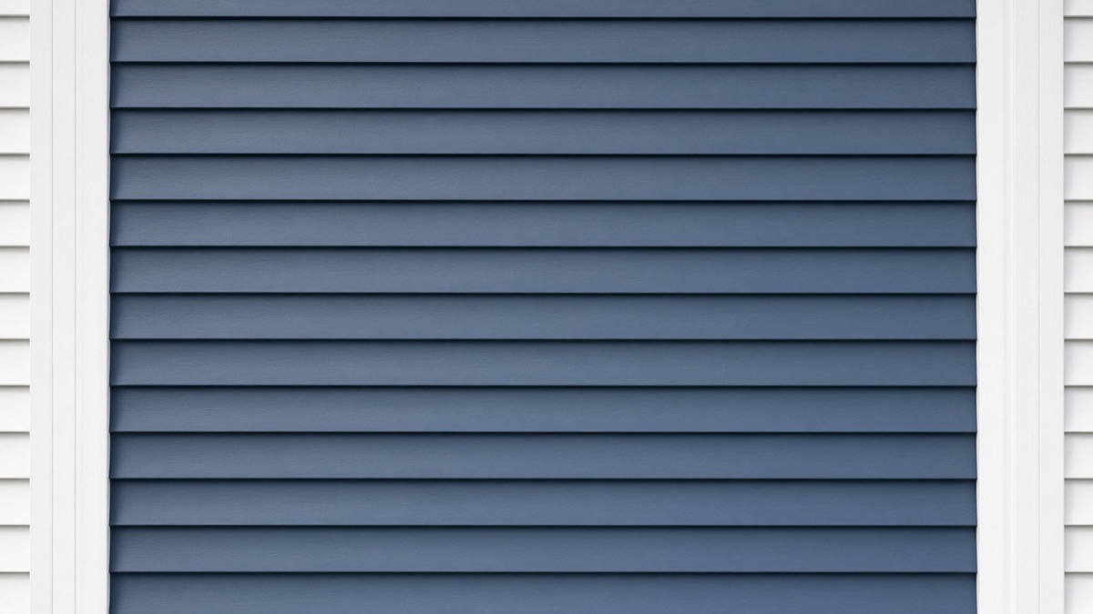 Slate-blue painted lap siding with white corner trim
